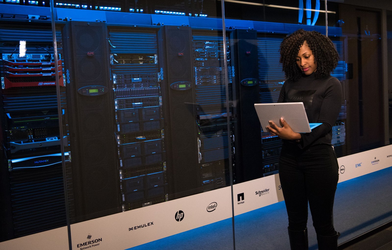 cloud-hosting IT engineer working beside server racks in a data center