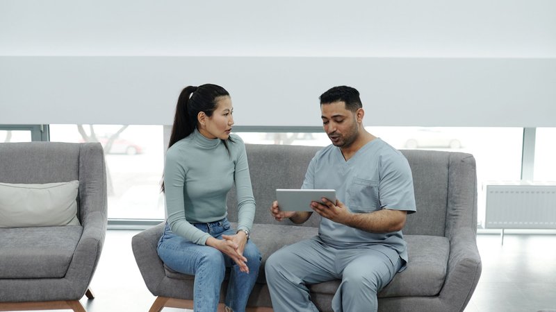 Doctor showing a patient health information on a digital tablet